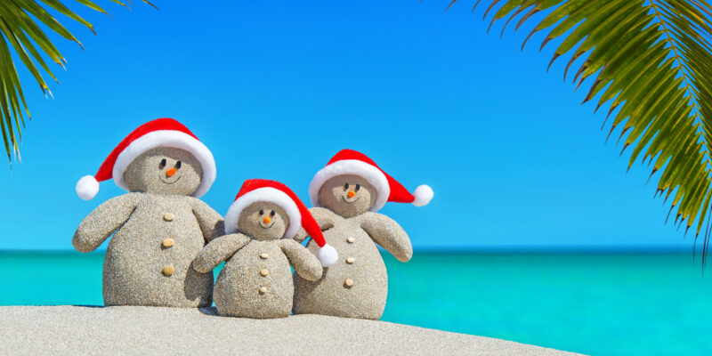 Positive,Sandy,Snowmen,Family,In,Red,Santa,Hats,At,Sunny